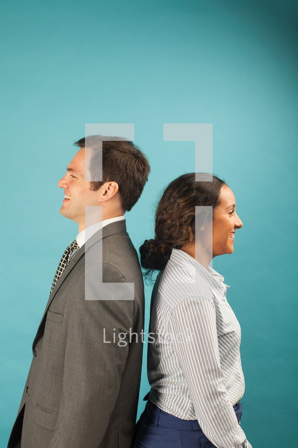 businesswoman and businessman standing back to back 