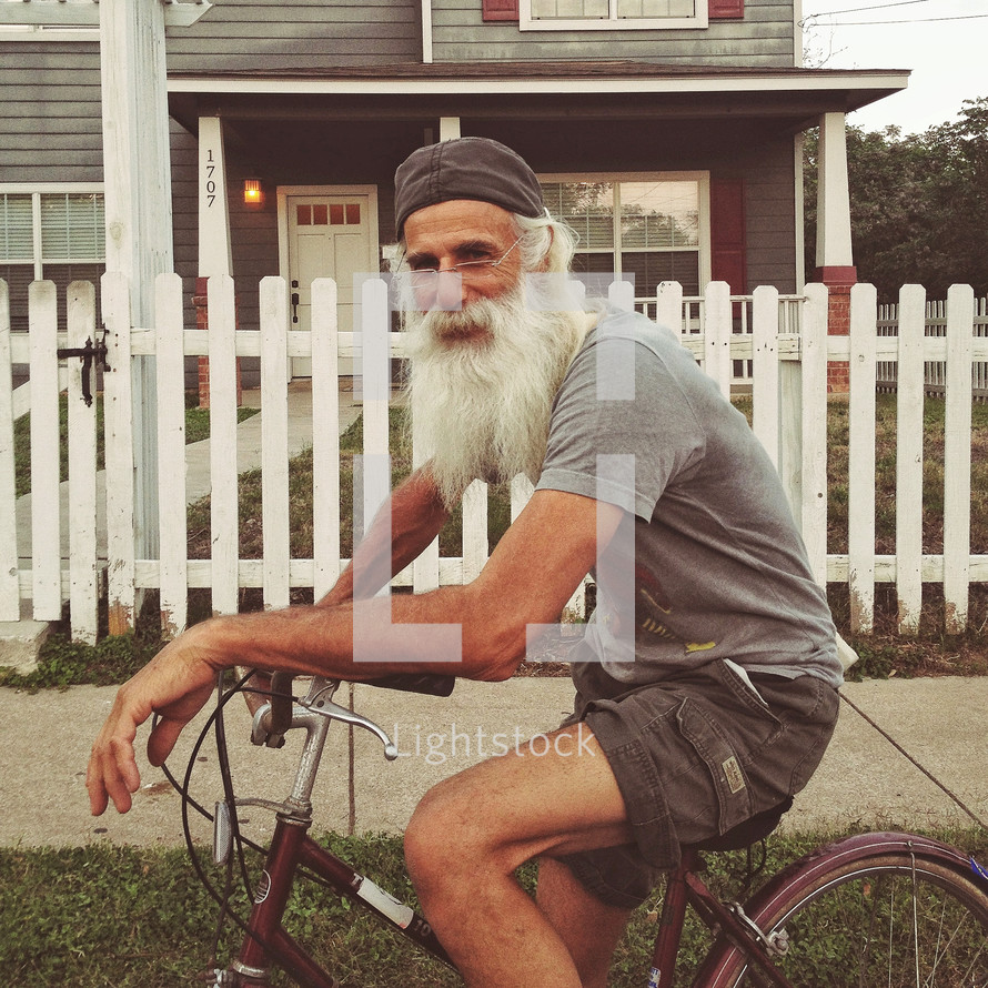 man with a beard riding a bicycle 
