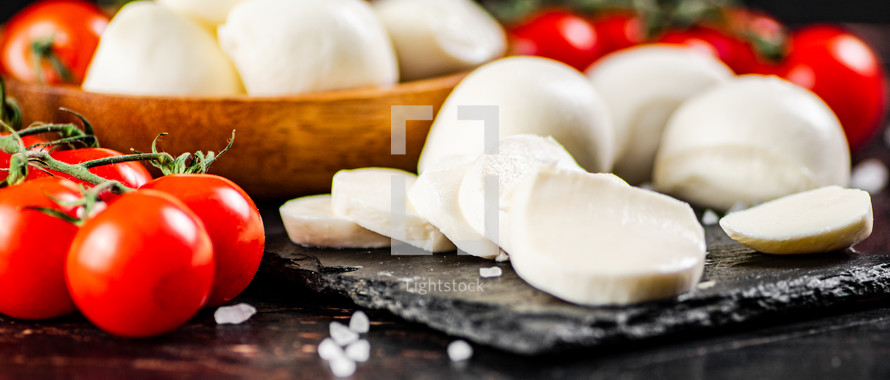 Mozzarella cheese on on rustic background. 
