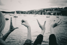 word love with hands and boats in water 