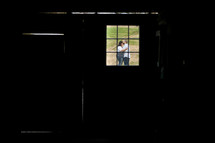 couple hugging outdoors through a window 