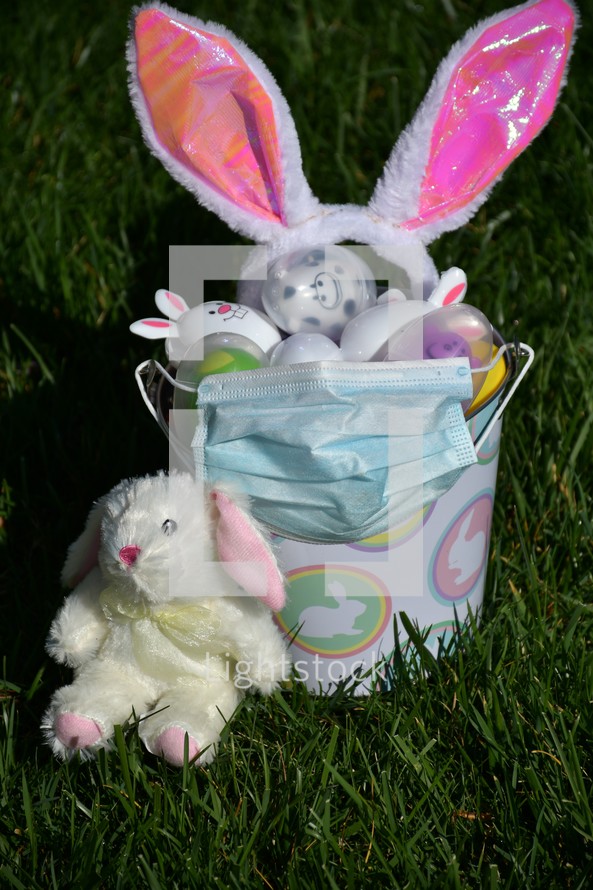 Easter basket filled with Easter eggs and a face mask 