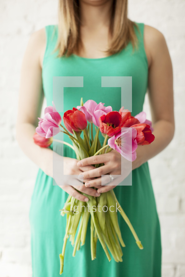 woman holding a bouquet of tulips 