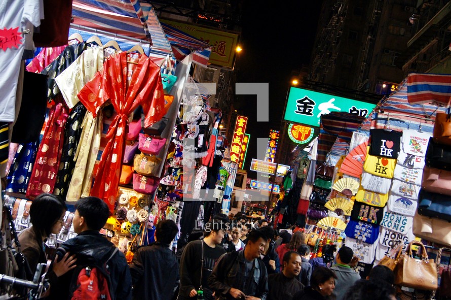 People shopping in a street market in Hong Kong, China at night 