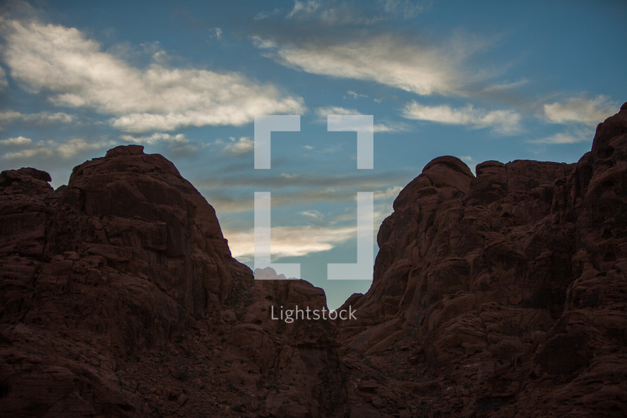 red rock cliffs and clouds in a blue sky 