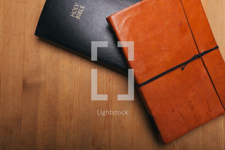 leather journal and Bible on a table 