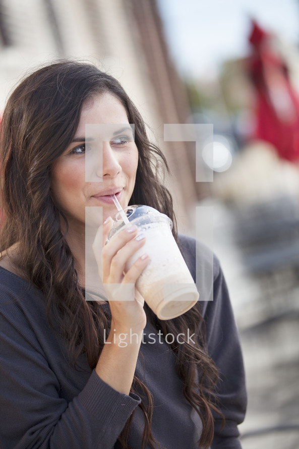 woman drinking a milkshake 