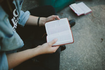 reading from a pocket bible