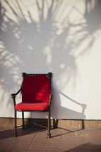 A red chair against a wall