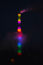 rainbow smokestack at night 
