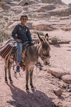 boy riding a donkey 