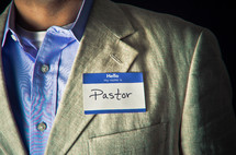 Man wearing "pastor" name tag