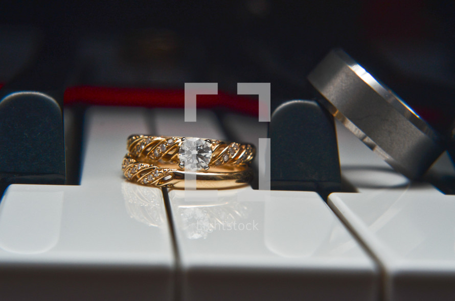 wedding rings on piano keys