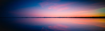 panorama view of a sunset over a lake 