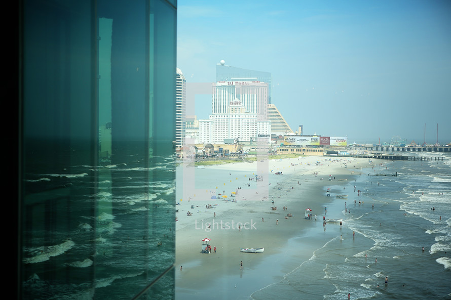 view of a crowded beach from a hotel room window 