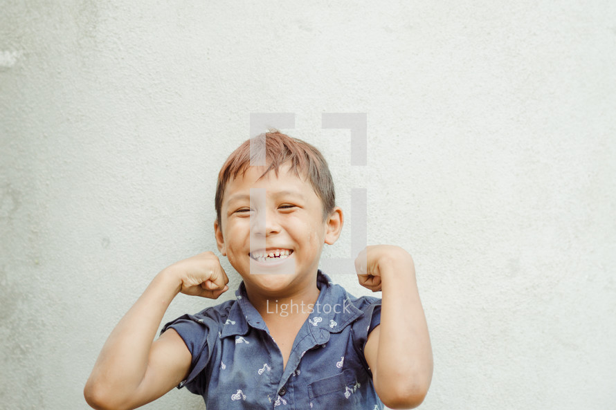 kid showing muscles 