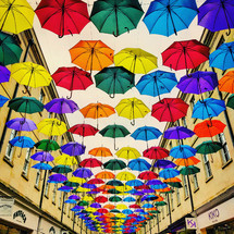 colorful umbrellas above a sidewalk 