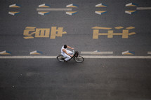a man riding a bicycle on a road in China 