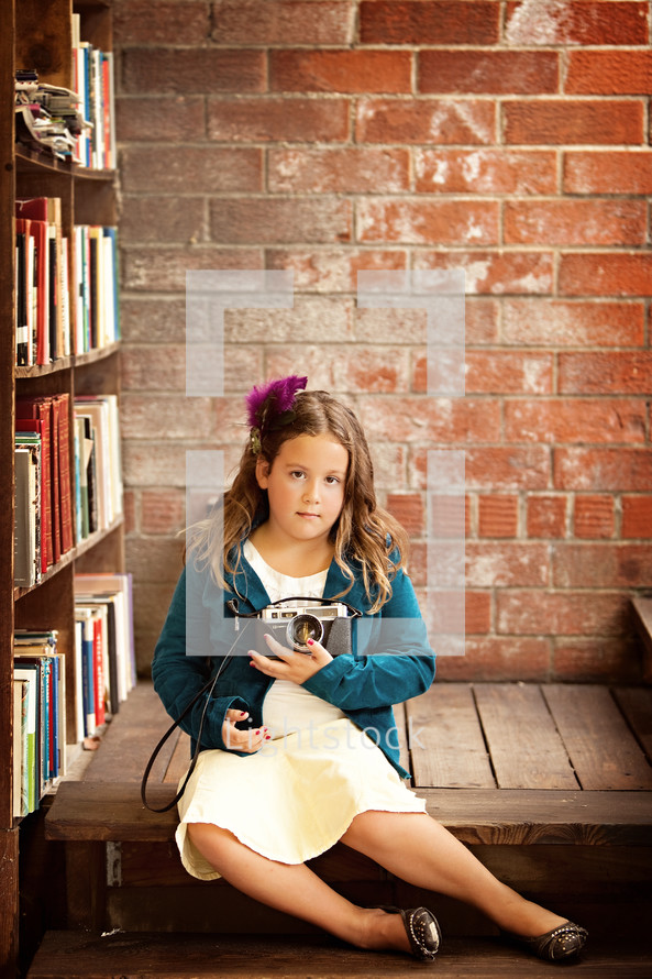 girl child holding a camera