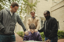 Bible study with men praying