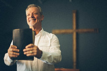 pastor holding a bible during a worship service