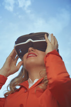 a woman in VR glasses outdoors 