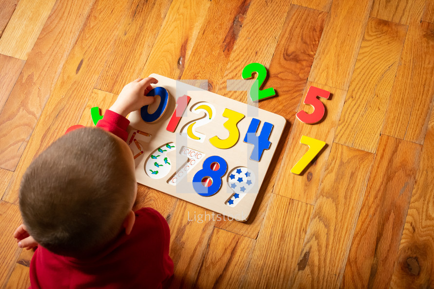 toddler playing with a puzzle 