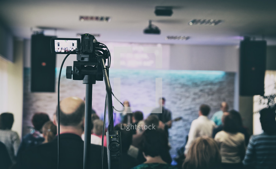 filming worship leaders on stage during a worship service 