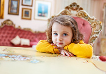 Portrait of girl toddler in a living room with baroque decor.
