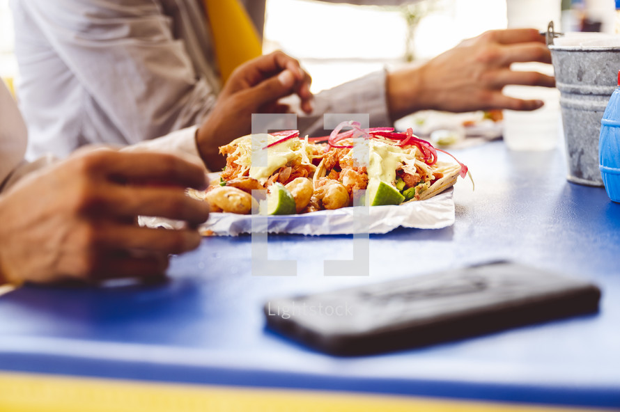 people eating food at a table in Mexico 