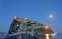 Aragonese Castle by night in Ischia island, Italy