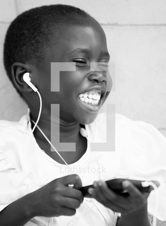 joyful child listening to music on an iPod 
