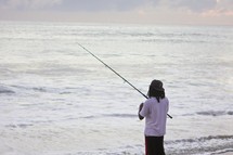 man fishing in the ocean