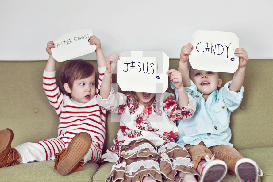 Siblings holding up Easter signs 