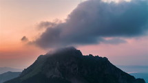 Colorful sky clouds moving over alpine mountains peak in summer morning nature Time lapse
