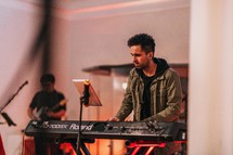 a man playing a keyboard during a worship service 