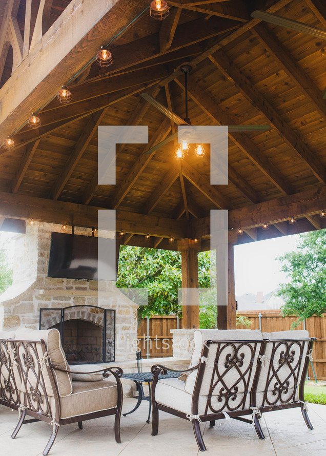 covered patio with fireplace and TV