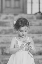 a little girl holding a tiara 