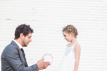a father giving his daughter a tiara 