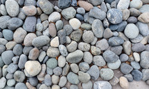 A background image of round stones grey, blue and white in color. 