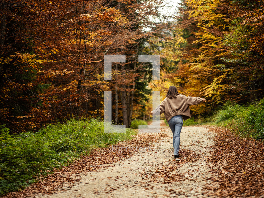 Woman walking on fall path