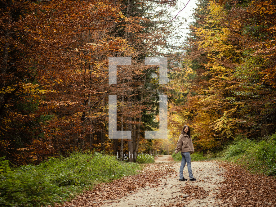 Woman posing on fall path
