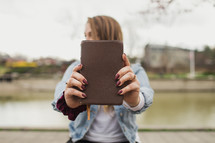 young woman holding a Bible 