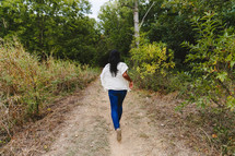 woman running outdoors on a path 