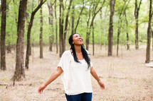 open arms, woman, standing, outdoors, rejoicing, joy, African American 