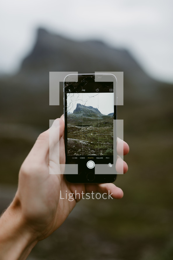 taking a picture of a mountain peak in Norway with a smartphone 