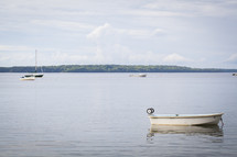 boats anchored on lake water 