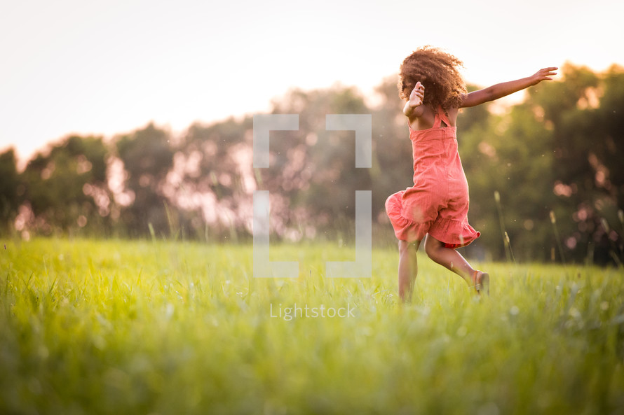 an excited girl running in grass 