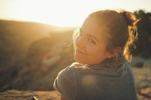 face of a smiling woman at sunset 