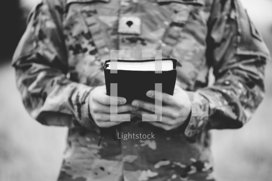 soldier holding a Bible 